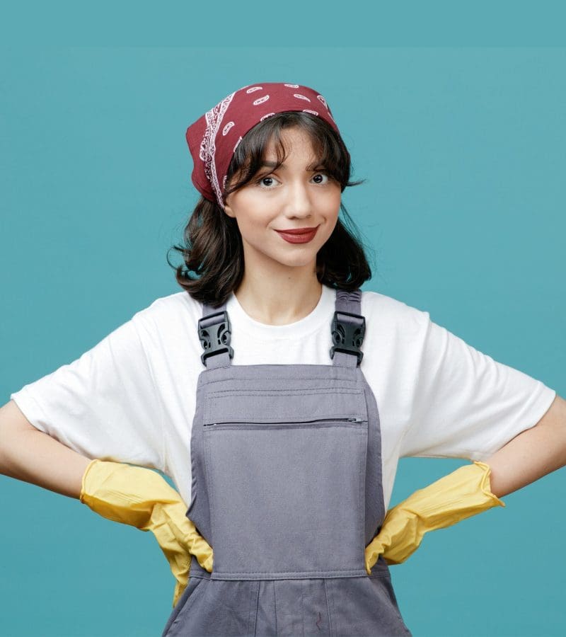 Female cleaner smiles at the camera